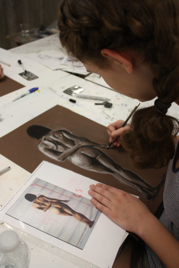 student drawing human figure